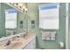 A bright bathroom with double sinks, white stone countertops and large mirror at 11031 Hyacinth Pl, Lakewood Ranch, FL 34202