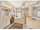 Bright bathroom with double sinks, soaking tub, walk-in shower and vanity area at 11031 Hyacinth Pl, Lakewood Ranch, FL 34202