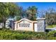 The Riverwalk Hammock community sign is surrounded by lush greenery and stone pillars at 11031 Hyacinth Pl, Lakewood Ranch, FL 34202