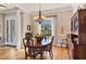 Elegant dining area with a wooden table, chandelier, and a decorative window adding character to the space at 11031 Hyacinth Pl, Lakewood Ranch, FL 34202