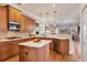 Well lit kitchen with wood cabinets, white stone countertops and stainless steel appliances at 11031 Hyacinth Pl, Lakewood Ranch, FL 34202