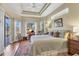 Serene main bedroom with tray ceiling, large windows, and en-suite bathroom access at 11031 Hyacinth Pl, Lakewood Ranch, FL 34202