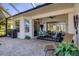 A covered patio with comfortable outdoor seating offers a great space for relaxation and entertainment at 11031 Hyacinth Pl, Lakewood Ranch, FL 34202