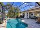 A screened in pool and patio area with multiple seating areas at 11031 Hyacinth Pl, Lakewood Ranch, FL 34202