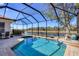 Sparkling pool with a scenic lake view and a screened enclosure at 11031 Hyacinth Pl, Lakewood Ranch, FL 34202