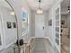 Bright foyer featuring wood floors, a stylish pendant light, and white paneled doors leading to other rooms at 11513 Trailwood Dr, Venice, FL 34293