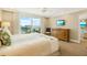 Bedroom boasts water view, dresser, and light walls that create a vacation-like atmosphere at 1212 Benjamin Franklin Dr # 1103, Sarasota, FL 34236