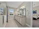 Bathroom featuring double vanity, granite countertop, and tiled floors leading to bedroom at 12423 Blue Hill Trl, Lakewood Ranch, FL 34211