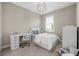Cozy bedroom with a desk, comfy bed, and ample natural light from a large window at 12423 Blue Hill Trl, Lakewood Ranch, FL 34211