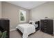 Bedroom with a comfortable bed, bedside table, and a window for natural light at 12423 Blue Hill Trl, Lakewood Ranch, FL 34211
