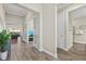 Inviting hallway with wood-look tile flooring and french doors leading to a bright living area at 12423 Blue Hill Trl, Lakewood Ranch, FL 34211