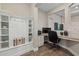 Dedicated home office featuring custom shelving, built-in desk, and granite countertop at 12423 Blue Hill Trl, Lakewood Ranch, FL 34211