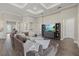 Expansive living room featuring hardwood floors, a large sofa, built-in shelving, and natural light at 12423 Blue Hill Trl, Lakewood Ranch, FL 34211