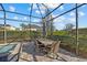 Outdoor patio area with dining table and seating next to the pool and spa at 12423 Blue Hill Trl, Lakewood Ranch, FL 34211