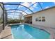 Screened-in pool and spa with an outdoor kitchen and patio seating area at 12423 Blue Hill Trl, Lakewood Ranch, FL 34211