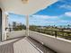 A tiled balcony offering scenic views of the city and waterfront beyond the mature trees at 1255 N Gulfstream Ave # 407, Sarasota, FL 34236