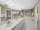 Elegant bathroom featuring dual sinks, a soaking tub, and tile flooring at 1255 N Gulfstream Ave # 407, Sarasota, FL 34236