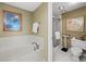 Bright bathroom featuring a soaking tub and separate glass-enclosed shower at 1255 N Gulfstream Ave # 407, Sarasota, FL 34236