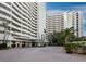Upscale condo building features a circular facade, tropical landscaping, and elegant entrance in a desirable location at 1255 N Gulfstream Ave # 407, Sarasota, FL 34236