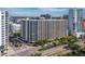 High-rise condo building with multiple balconies showcasing city views and accessible street parking and palm trees at 1255 N Gulfstream Ave # 407, Sarasota, FL 34236