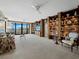 Spacious living room with custom built-in bookshelves and water views at 1255 N Gulfstream Ave # 407, Sarasota, FL 34236