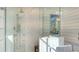 Luxurious shower with marble tile and glass enclosure with a view of shiplap wall at 1516 Sandpiper Ln, Sarasota, FL 34239