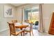 Cozy dining area featuring a round table, wood chairs, and sliding glass doors to the outside at 1774 Woodleaf Hammock Ct, Bradenton, FL 34212