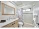 Bright bathroom featuring a shower-tub combo and a wood vanity sink at 216 68Th St Nw, Bradenton, FL 34209