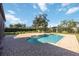 Backyard pool features a brick paver deck, mature landscaping, and a charming umbrella table at 216 68Th St Nw, Bradenton, FL 34209