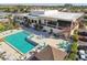 Aerial view of community pool, patio, and gathering spaces at a clubhouse or community center at 2311 14Th W Ave # 108, Palmetto, FL 34221