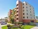 This is a beautiful exterior of the Ten Downing Street condos with lush landscaping and palm trees at 2311 14Th W Ave # 108, Palmetto, FL 34221