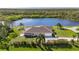 Aerial view of the property with lush landscaping and lake views at 25906 83Rd E Ave, Myakka City, FL 34251