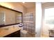 Well-lit bathroom featuring a vanity, mirror, and shower and tub combo at 25906 83Rd E Ave, Myakka City, FL 34251