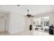 Bright living room with tile flooring and sliding glass doors to a screened patio at 25906 83Rd E Ave, Myakka City, FL 34251