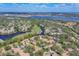 Picturesque aerial view of the community, featuring lush landscaping, water views, and a glimpse of the open water at 3214 Sandleheath # 64, Sarasota, FL 34235