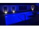 Inviting backyard pool featuring vibrant blue lighting, perfect for evening relaxation and outdoor entertaining at 3746 Glen Oaks Manor Dr, Sarasota, FL 34232