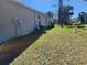 Wide backyard with sparse grass and an AC unit sitting outside the home and along the foundation at 3799 Laredo Ave, North Port, FL 34288