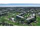 A wide aerial shot captures the community layout, featuring buildings, landscaping, and water features at 3860 Ironwood Ln # 503G, Bradenton, FL 34209