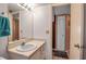 This is a bathroom with a single sink vanity with drawers and white door leading to a closet at 3860 Ironwood Ln # 503G, Bradenton, FL 34209