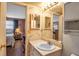 Well-lit bathroom area with classic wallpaper adjoining a bedroom at 3860 Ironwood Ln # 503G, Bradenton, FL 34209