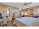Bright bedroom featuring wood floors, dresser, and access to an ensuite bathroom at 3860 Ironwood Ln # 503G, Bradenton, FL 34209