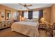 Warm bedroom with a queen bed and dual nightstands beneath a ceiling fan at 3860 Ironwood Ln # 503G, Bradenton, FL 34209