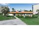 Exterior view of community building with xeriscaped yard, paved walkway and building signage at 3860 Ironwood Ln # 503G, Bradenton, FL 34209