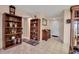 Inviting hallway with tile flooring, wooden bookcases, and neutral paint at 3860 Ironwood Ln # 503G, Bradenton, FL 34209