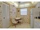 Charming eat-in kitchen with white table set and patterned wallpaper at 3860 Ironwood Ln # 503G, Bradenton, FL 34209