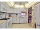 Bright kitchen featuring white appliances, tile backsplash, and a ceiling fan at 3860 Ironwood Ln # 503G, Bradenton, FL 34209