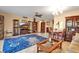 Open-concept living room with tile floors, ceiling fan, and a large area rug at 3860 Ironwood Ln # 503G, Bradenton, FL 34209