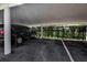 Covered parking spot featuring a dark colored minivan in a covered and lined parking spot at 3860 Ironwood Ln # 503G, Bradenton, FL 34209