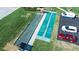 Aerial view of shuffleboard courts next to bocce ball court with ample parking nearby at 3860 Ironwood Ln # 503G, Bradenton, FL 34209