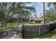 Charming property with a well-kept lawn, mature trees, a wooden fence, and visible house number at 3960 Sunshine Ave, Sarasota, FL 34231